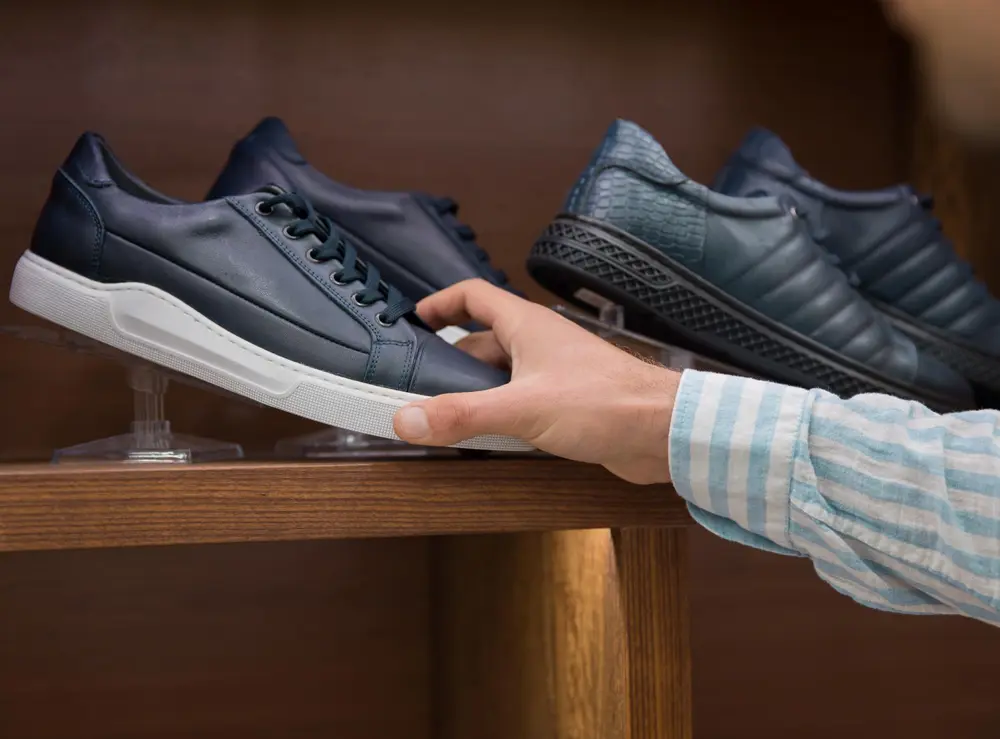 man-shopping-shoes-shop_225446-1642